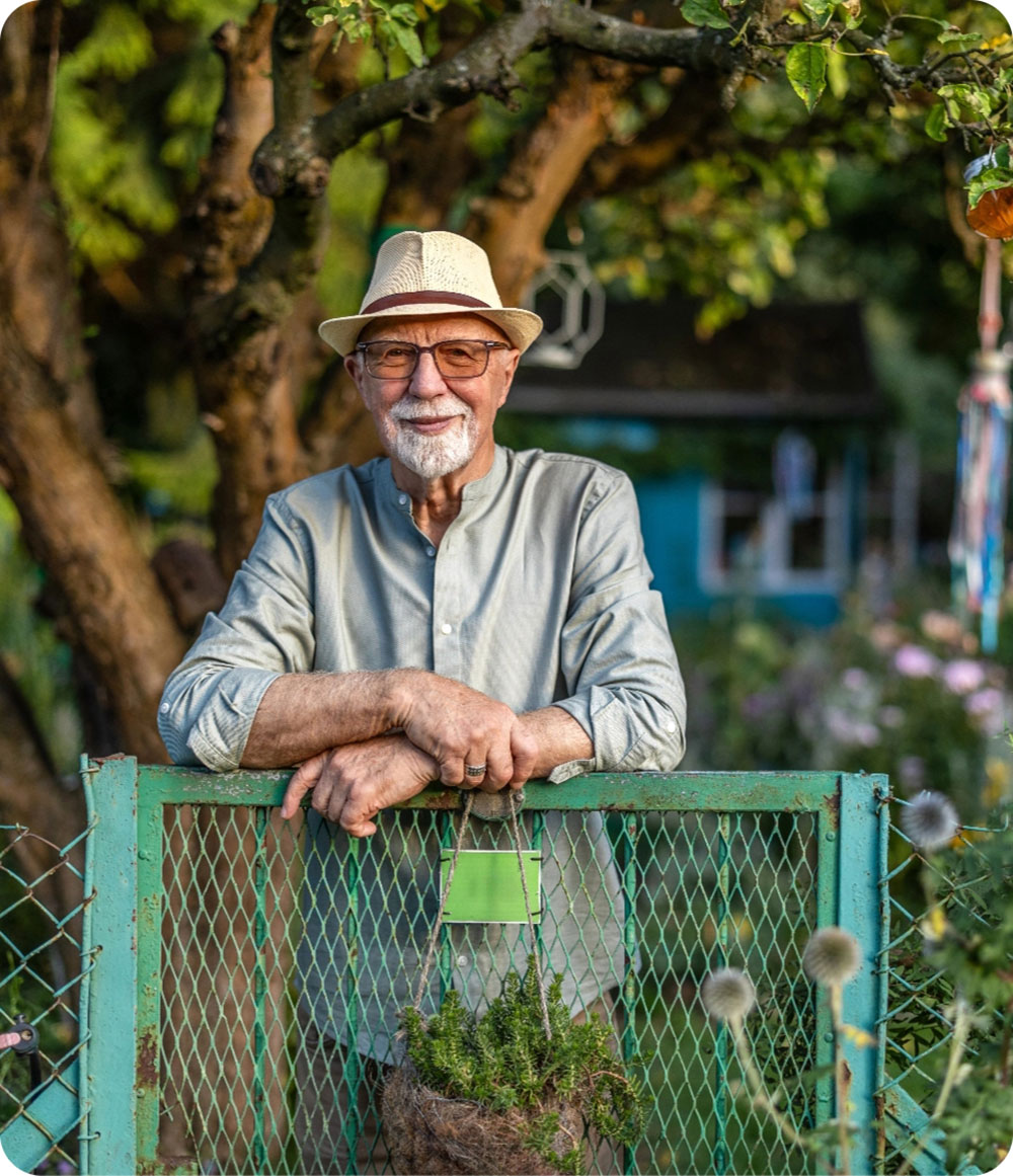 Old man standing in front yard